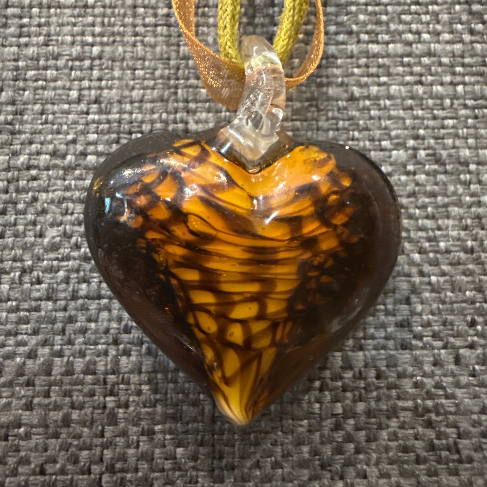 Art glass heart pendant on 16” ribbon.
